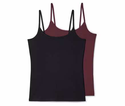 Zwei Tanktops liegen übereinander, eines in Schwarz und eines in Burgunderrot, beide mit Spaghettiträgern und Spitzenbesatz.