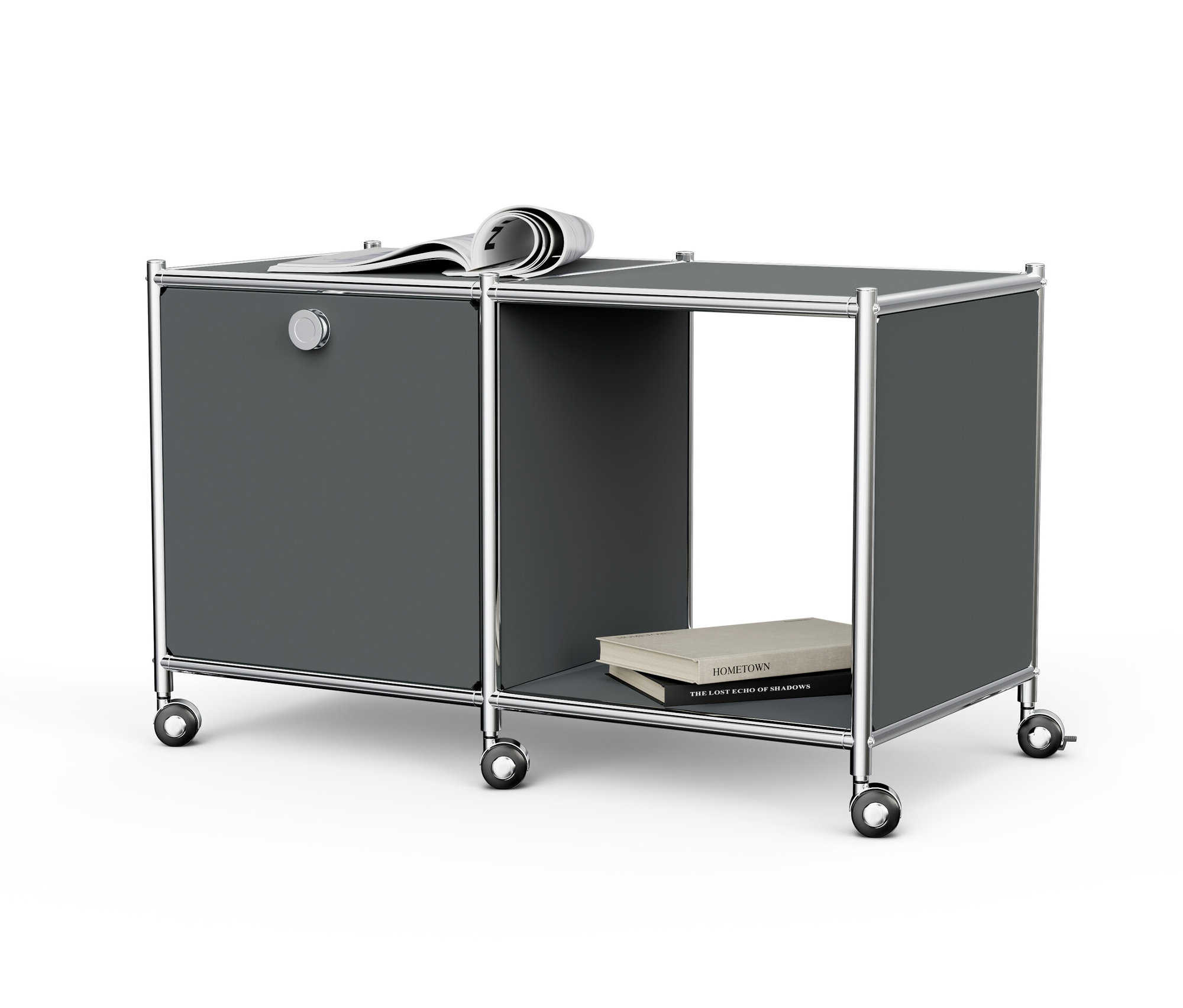 Ein grauer Beistelltisch Metall »CN3« mit einem Klappfach, Rollen, einer Zeitung oben und Büchern im offenen Fach.