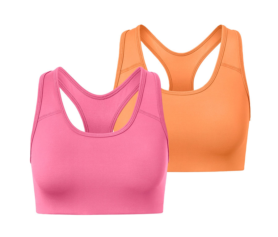 Zwei Sport-Bustiers, eines in Pink und eines in Orange, liegen nebeneinander.