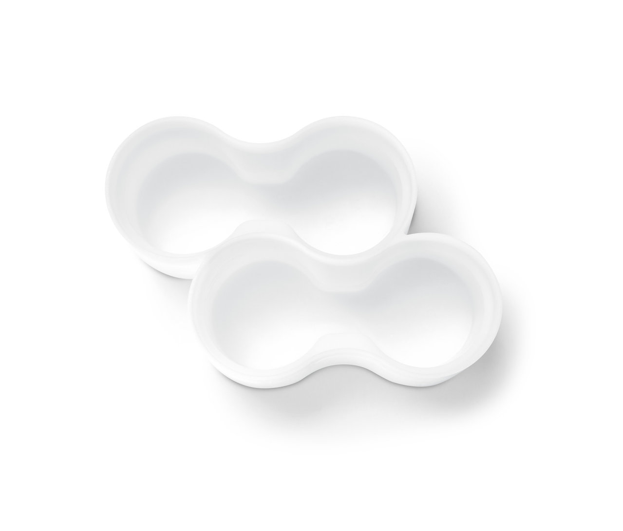 Zwei weiße Tubenhalter auf weißem Hintergrund.