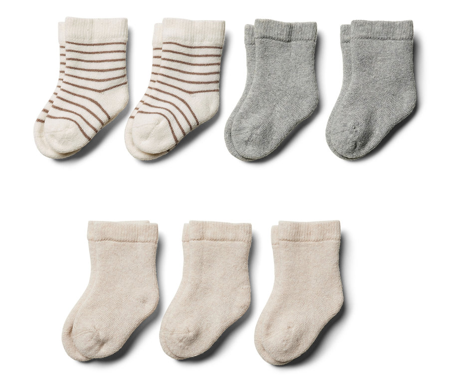 Sieben Paar Baby-Frottier-Socken in verschiedenen Farben und Mustern.