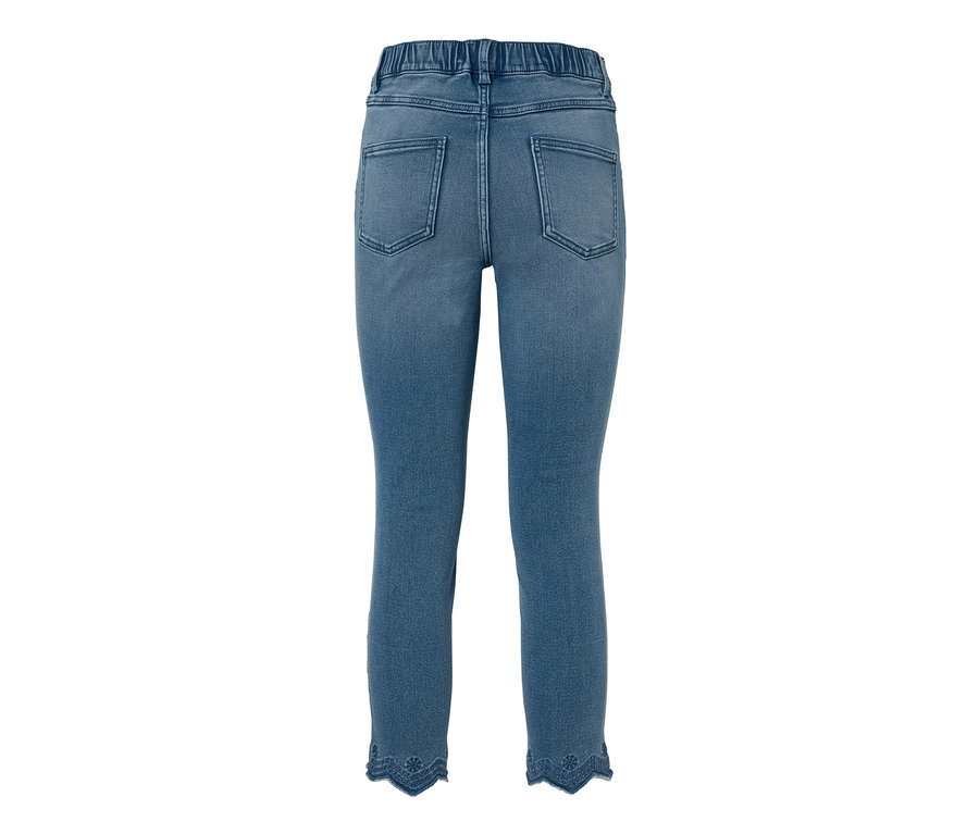 Blaue 7/8-Treggings mit Lochstickerei am Beinabschluss.
