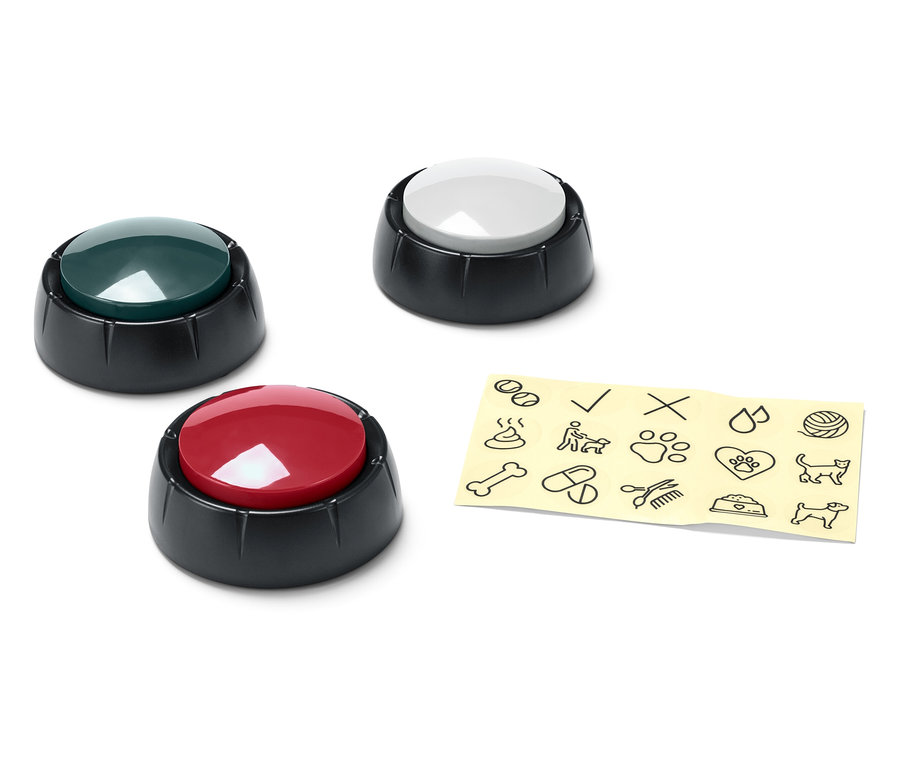 Drei verschiedenfarbige Knöpfe (grün, weiß und rot) neben einem gelben Zettel mit schwarzen Comiczeichnungen.