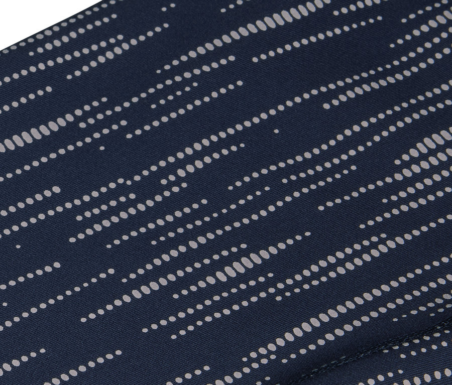 Detailaufnahme eines marineblauen Stoffes mit einem Muster aus parallelen weißen Punkten.