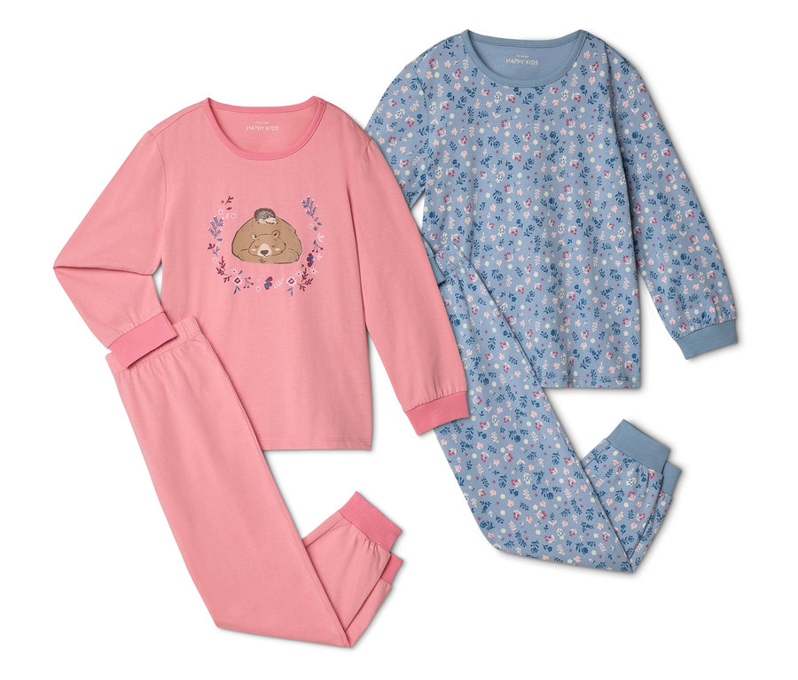 Zwei Schlafanzüge liegen nebeneinander, einer rosa mit Bär und Igel, der andere blau mit Blumenmuster.