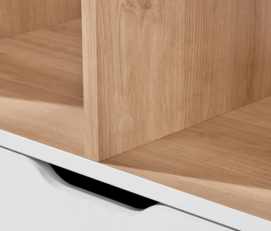 Detailaufnahme eines Sideboards mit Schublade, weiße Schublade und Holzregal.