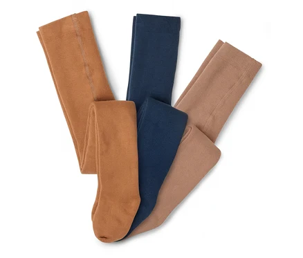 Drei Strumpfhosen in den Farben Braun, Dunkelblau und Hellbraun liegen übereinander.