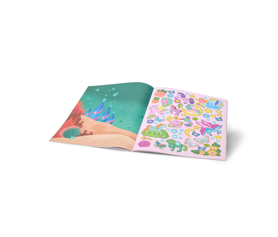 Ein offenes Stickerbuch zeigt links eine Unterwasserszene mit Sand und Korallen, rechts bunte Einhorn-, Schmetterlings- und Blumensticker auf rosa Hintergrund.