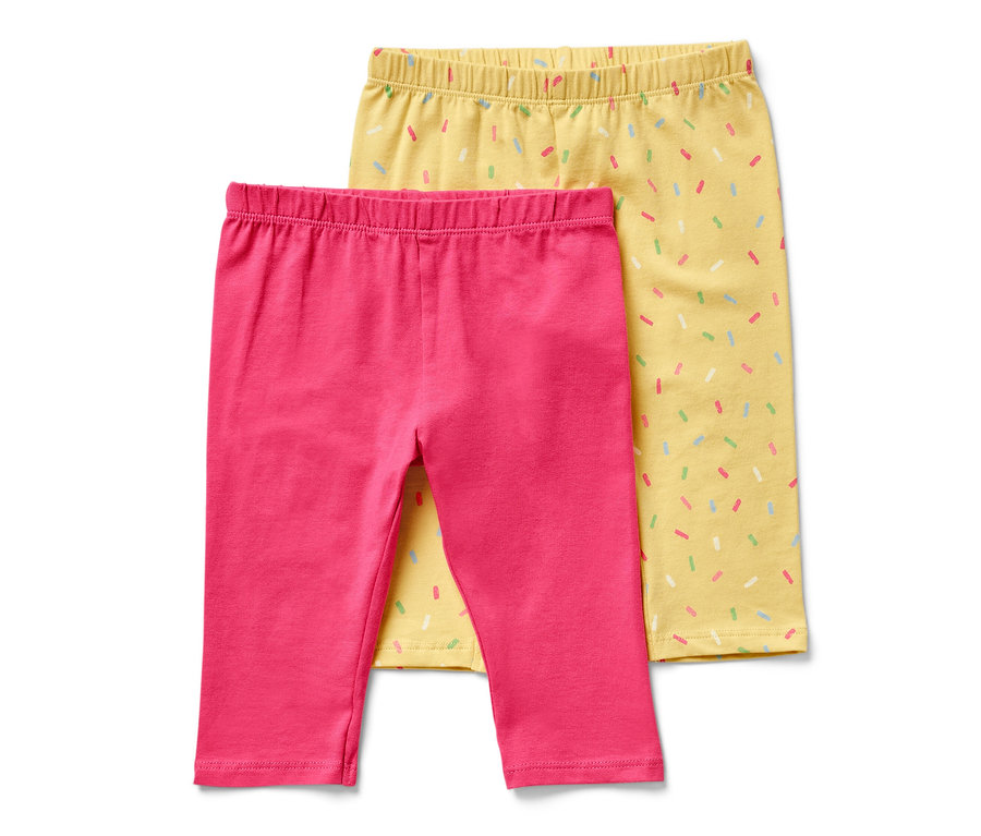 Zwei ¾-Kinder-Leggings, eine pink und eine gelb mit bunten Streuseln.