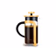 Eine gelbe French Press Kaffeekanne aus Glas mit schwarzem Griff ist mit Kaffee gefüllt.