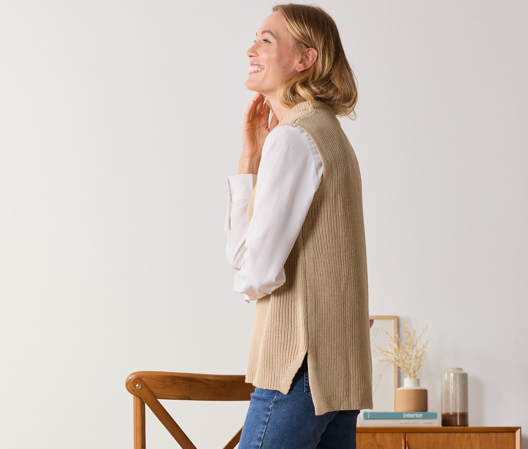 Frau posiert in Strick-Pullunder.