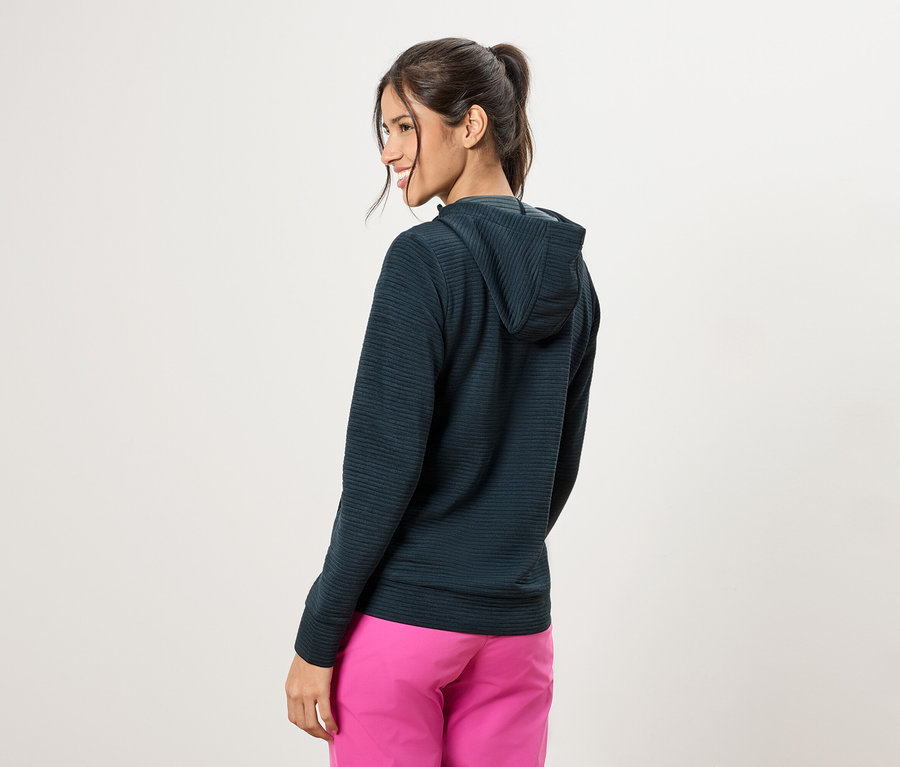 Frau von hinten, trägt einen dunkelgrünen Hoodie und pinke Hosen.