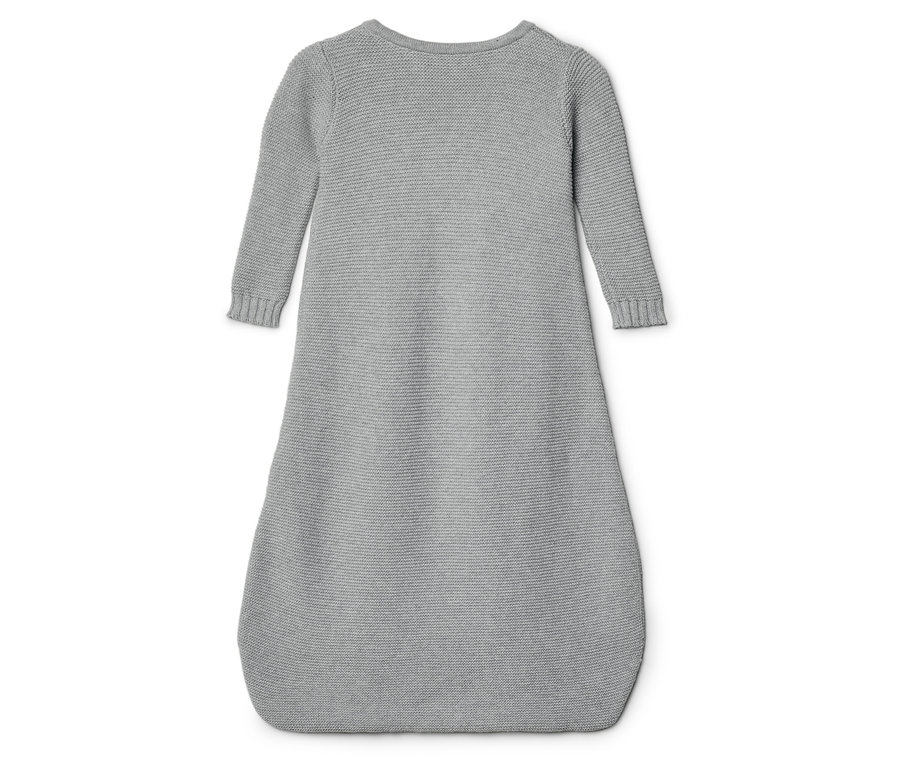 Ein grauer, gestrickter Schlafsack mit langen Ärmeln liegt auf einem weißen Hintergrund.