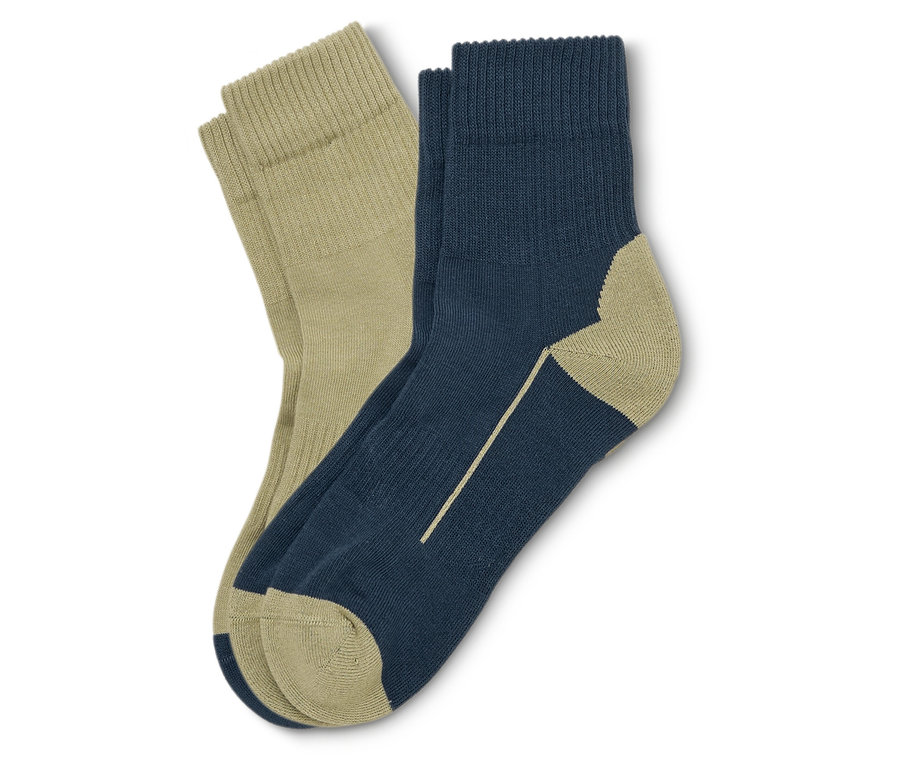 Ein Paar Socken, eine beige und eine marineblaue mit beigen Details, liegen übereinander.