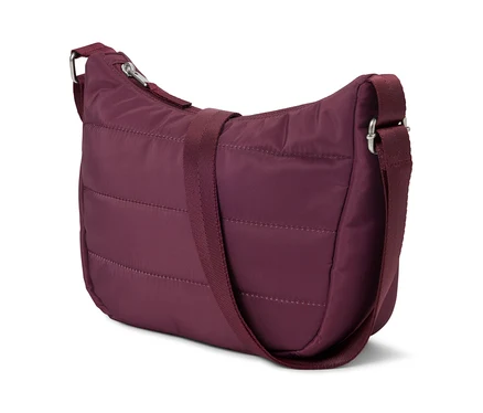 Eine bordeauxrote, gesteppte Handtasche mit verstellbarem Schultergurt liegt auf einem weißen Hintergrund.