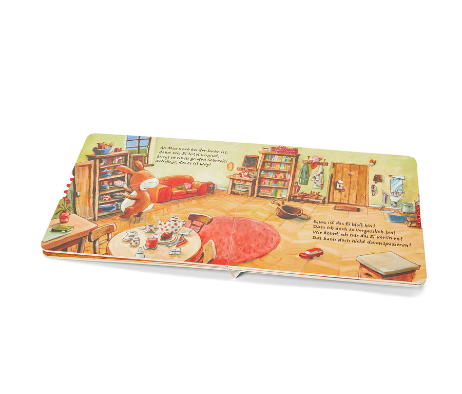 Aufgeschlagenes Buch zeigt Illustration eines Hasen in einem Zimmer. Zu sehen ist das Buch »Die große Eiersucherei«.