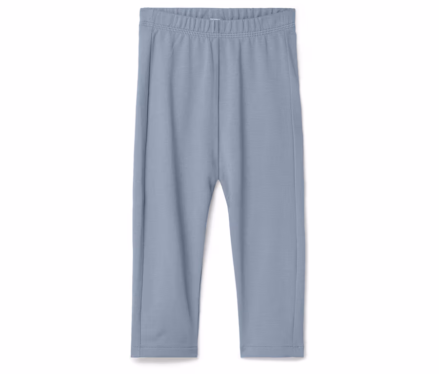 Hellblaue Leggings liegen auf einem weißen Hintergrund.