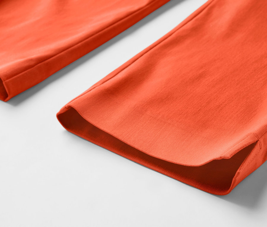 Detailansicht einer orangefarbenen 3/4-Stretchhose.