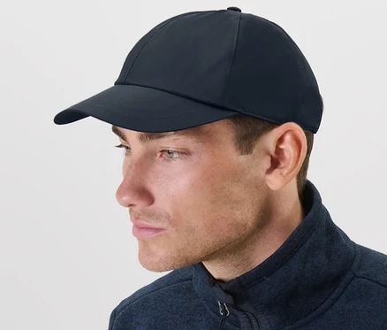 Mann trägt eine blaue Allwetter-Kappe und eine blaue Jacke.