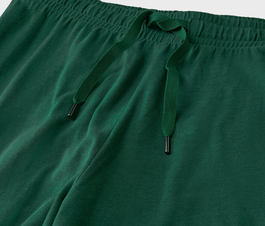 Detailaufnahme einer grünen Jogginghose mit Kordelzug.