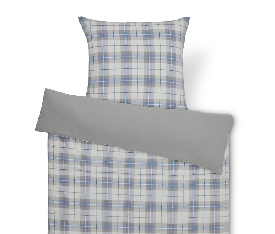 Ein Bettwäsche-Set mit Karomuster und einem grauen Kissenbezug.
