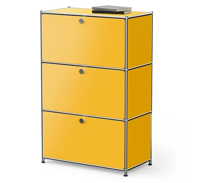 Gelber Schrank mit drei Schubladen und einem Buch darauf.