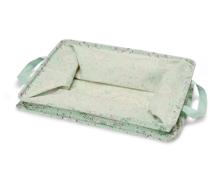 Eine hellgrüne faltbare Ordnungsbox mit Blumenmuster und hellgrünen Griffen.