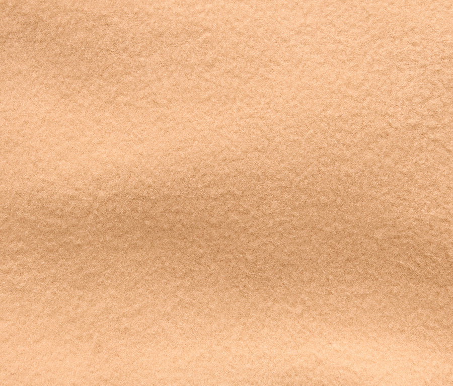 Nahaufnahme der Textur eines beigen Stoffes.