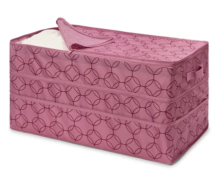 Rosa Stoffbox mit Reißverschluss und geometrischem Muster, teilweise mit weißem Stoff gefüllt.
