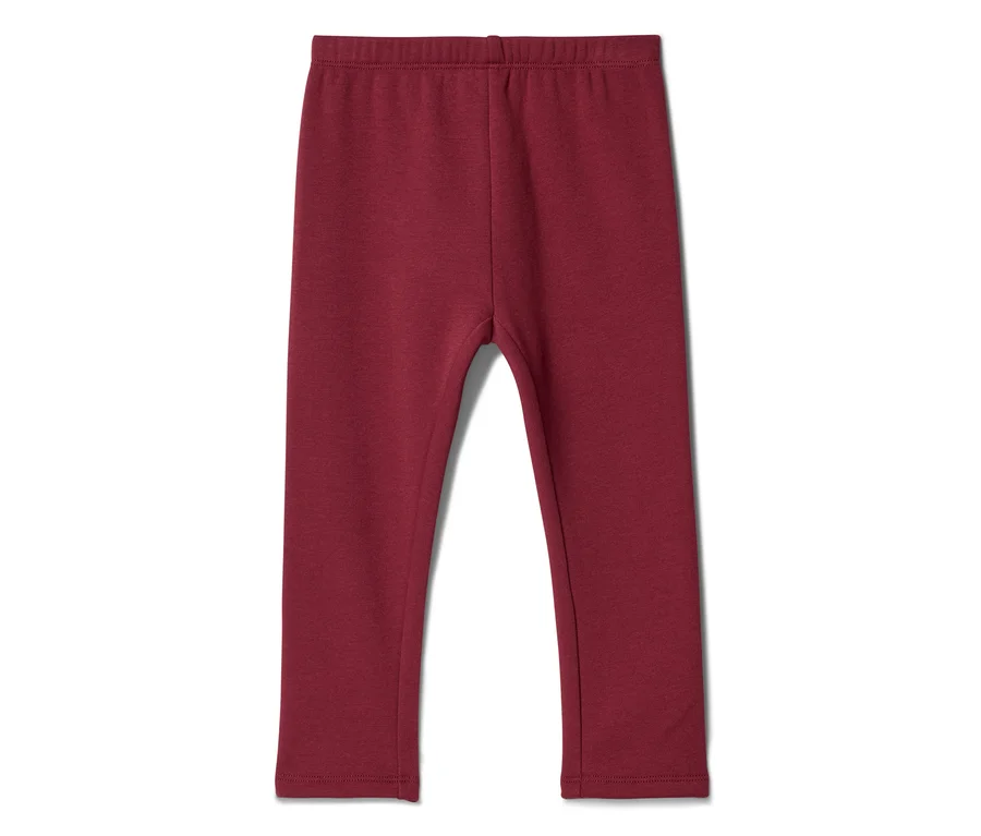Dunkelrote Kinderleggings, flach liegend auf weißem Hintergrund.