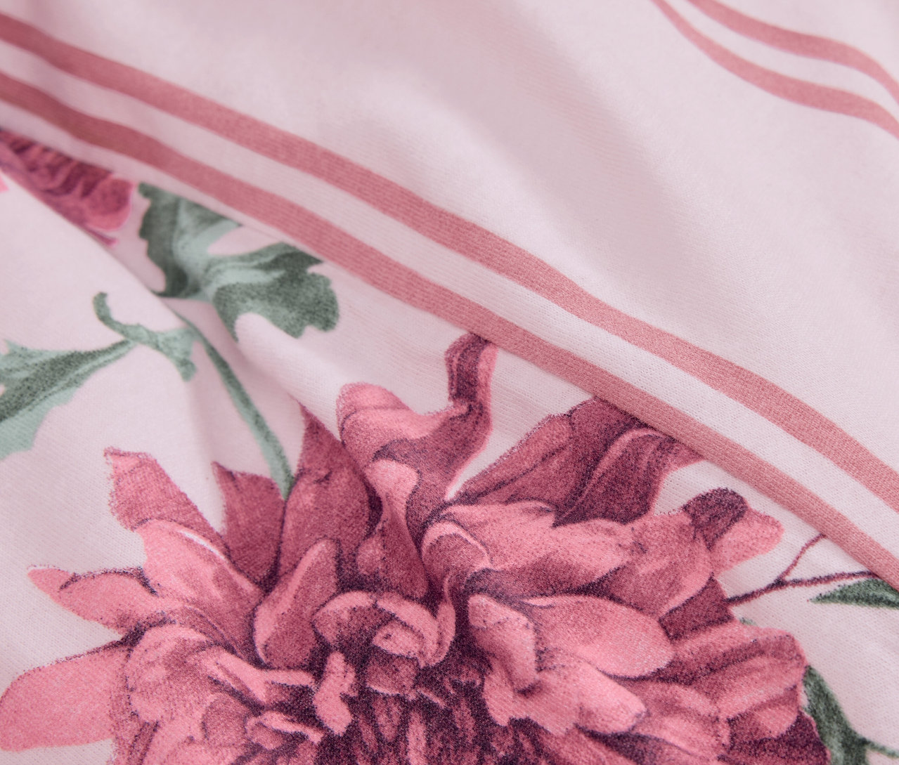 Detailaufnahme der Winterjersey-Bettwäsche, Normalgröße mit Blumenmuster und rosa Streifen.