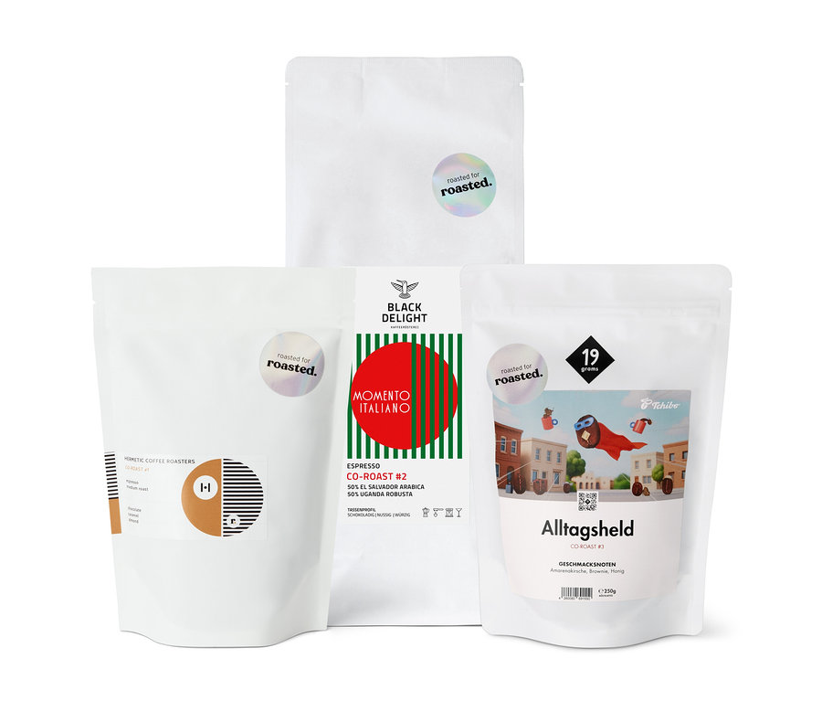 Vier Packungen Kaffeebohnen unterschiedlicher Röstungen stehen nebeneinander.
