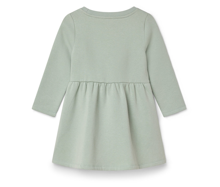 Ein hellgrünes Kinderkleid mit langen Ärmeln.