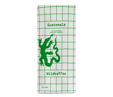 Packung Wildkaffee - Guatemala San Lorenzo Omni-Roast - 1 kg Ganze Bohne. Auf weißem Hintergrund ein grünes Gitter und eine grüne Abbildung eines Geckos.