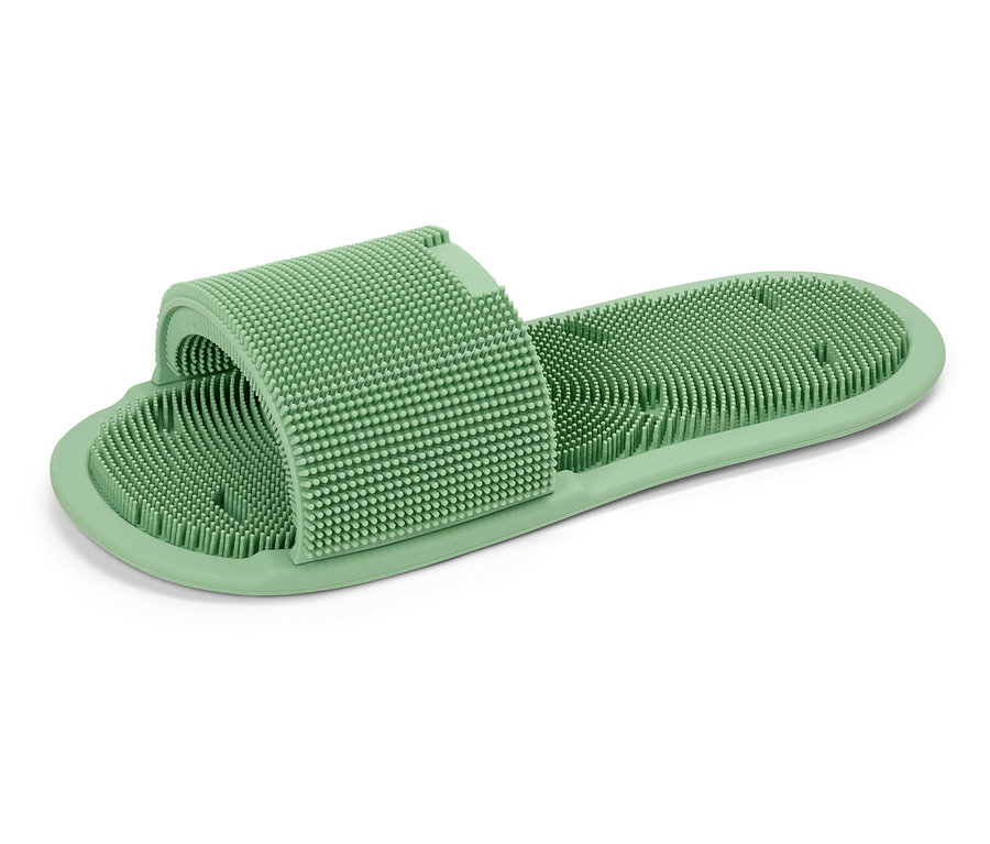Ein einzelner grüner Massage-Slipper mit Noppen.