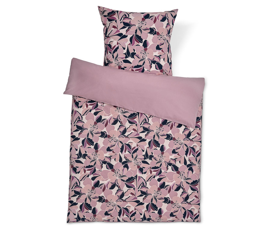 Bettwäsche-Set mit Blumenmuster und einfarbigem Kissenbezug.