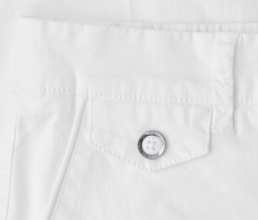 Nahaufnahme einer weißen Street One Chino, die eine Pattentasche mit einem silbernen Knopf zeigt, auf dem „STREET ONE CASUAL WEAR“ eingraviert ist, unterhalb des Bundes.