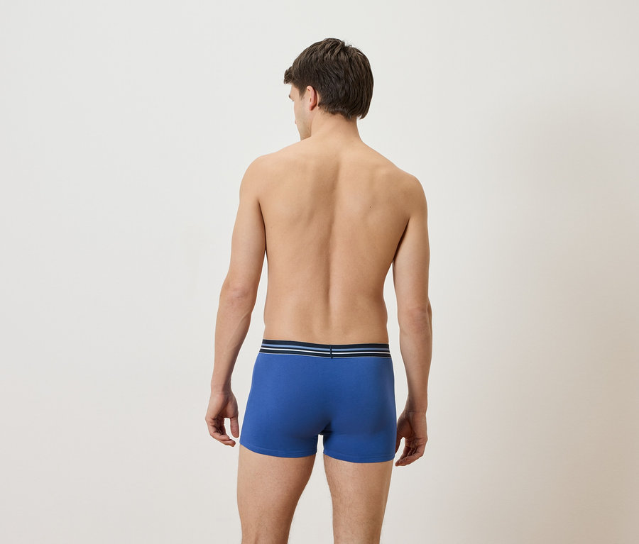 Mann von hinten, mit blauen Boxershorts.