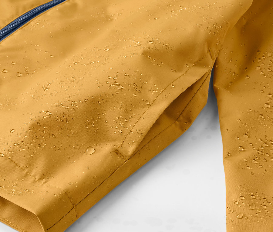 Detailaufnahme einer gelben Kinder-Regenjacke mit Wassertropfen.