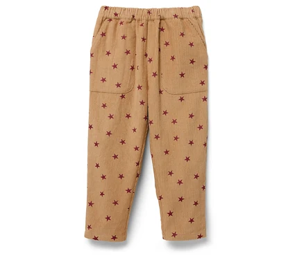 Beige Cordhose mit elastischem Bund und roten Sternen.