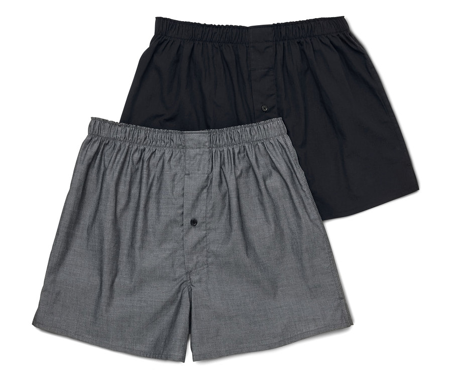 Zwei Herren Boxershorts, eine grau und eine schwarz, liegen übereinander.