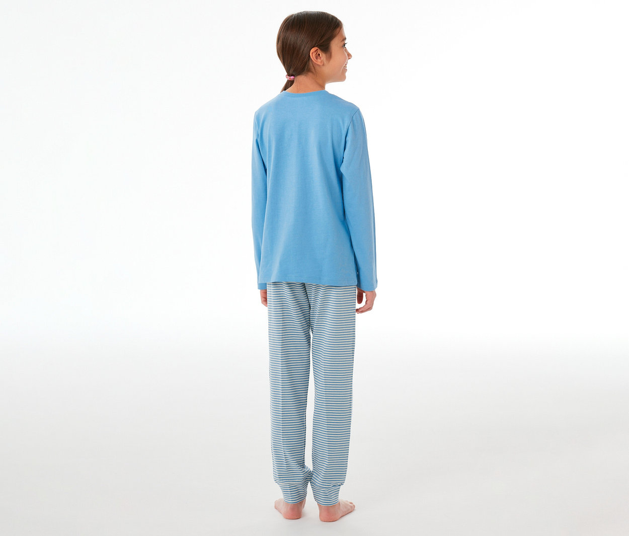 Mädchen von hinten, leicht nach rechts gedreht, trägt einen SCHIESSER Kinder-Pyjama mit blauem Langarmshirt und gestreiften Hosen.