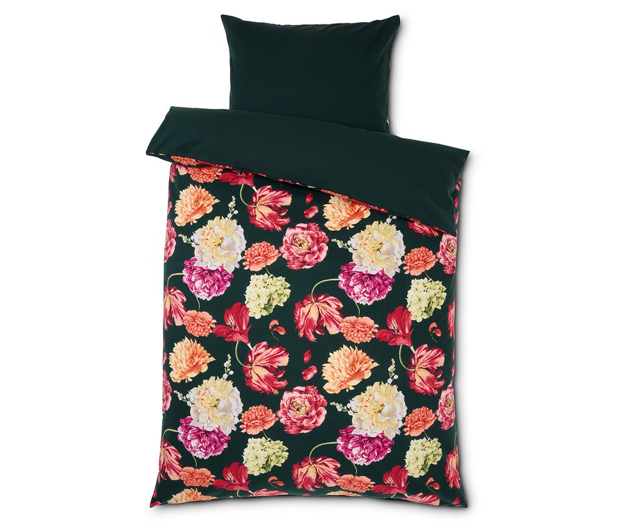 Bettwäsche mit Blumenmuster und dunkelgrünem Rand und Kissen.