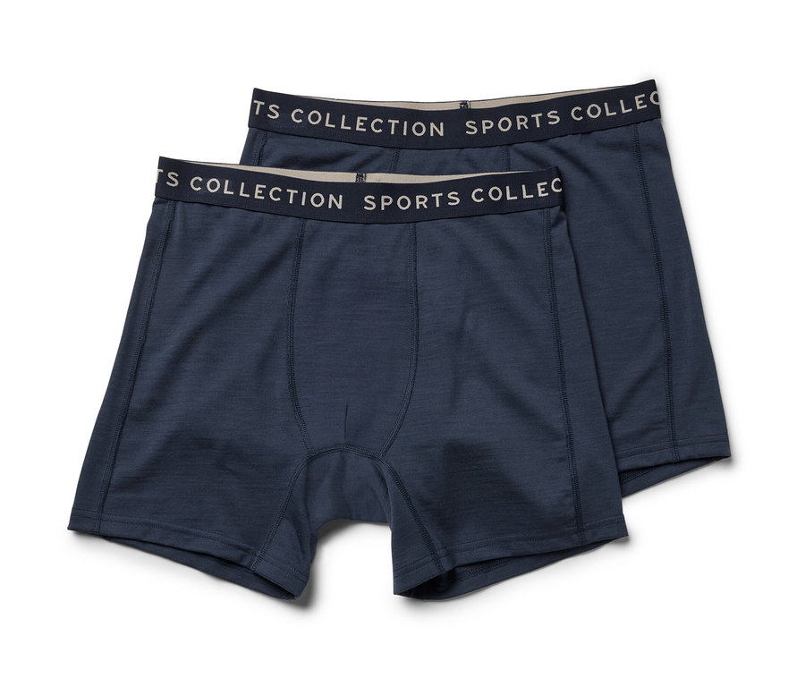 Zwei blaue Slipboxer mit Merinowolle liegen übereinander.
