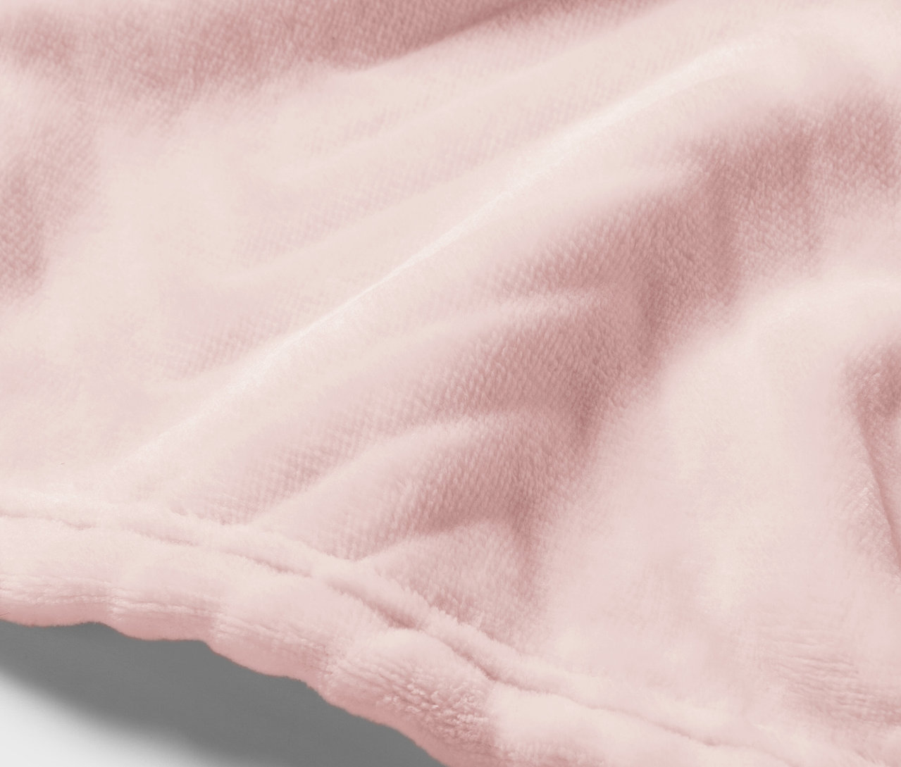 Detailaufnahme eines rosafarbenen Samtstoffes mit Naht.