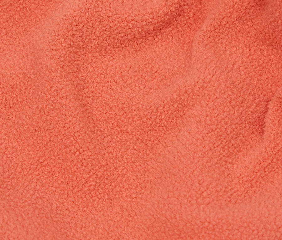 Nahaufnahme einer orangefarbenen Fleece-Textur.