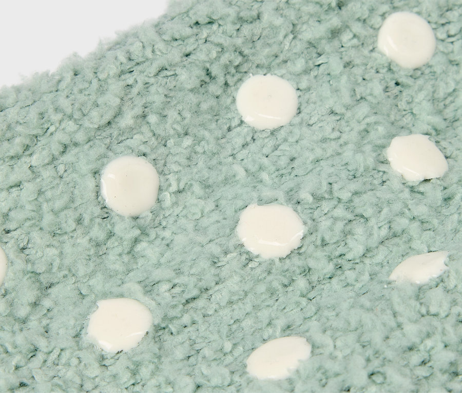 Nahaufnahme eines hellblauen Stoffes mit weißen Punkten.