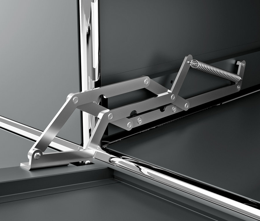 Detailansicht eines grauen CN3 Metall Schranks mit Klappfach und Mechanismus.