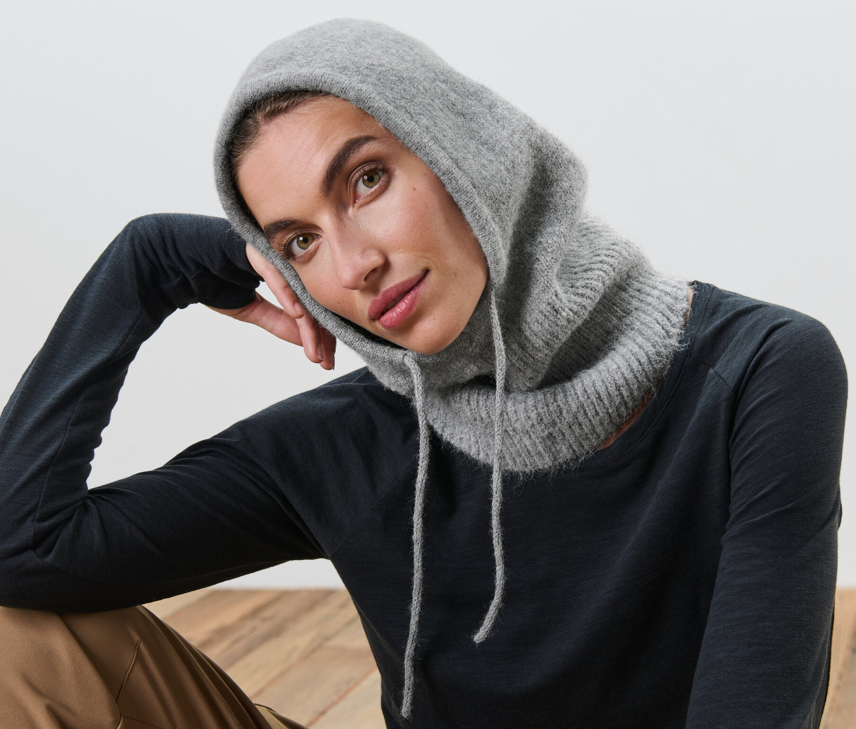 Frau posiert mit Strick-Kapuze mit Kragen.